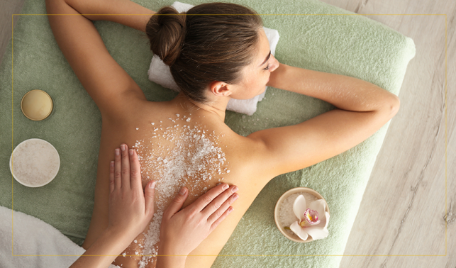 image of a woman receiving scrub on her back